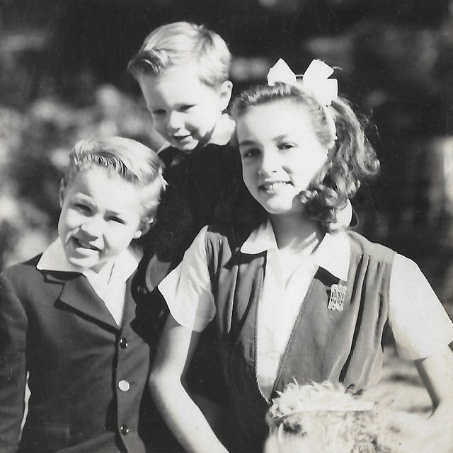 Julie Newmar childhood photo with her siblings in a formal dress.